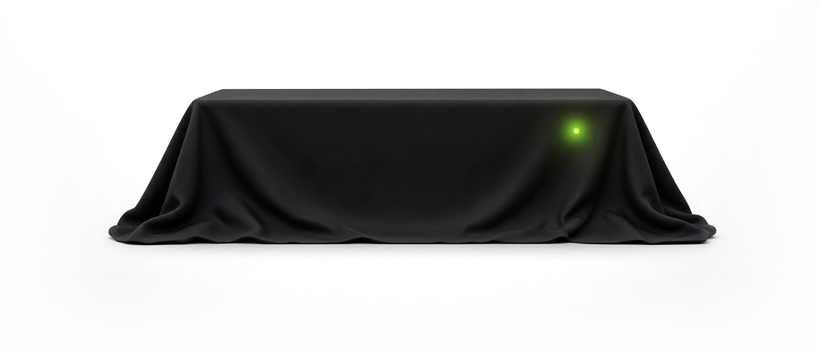 artifex one under a black cloth, with only its small lime light showing through